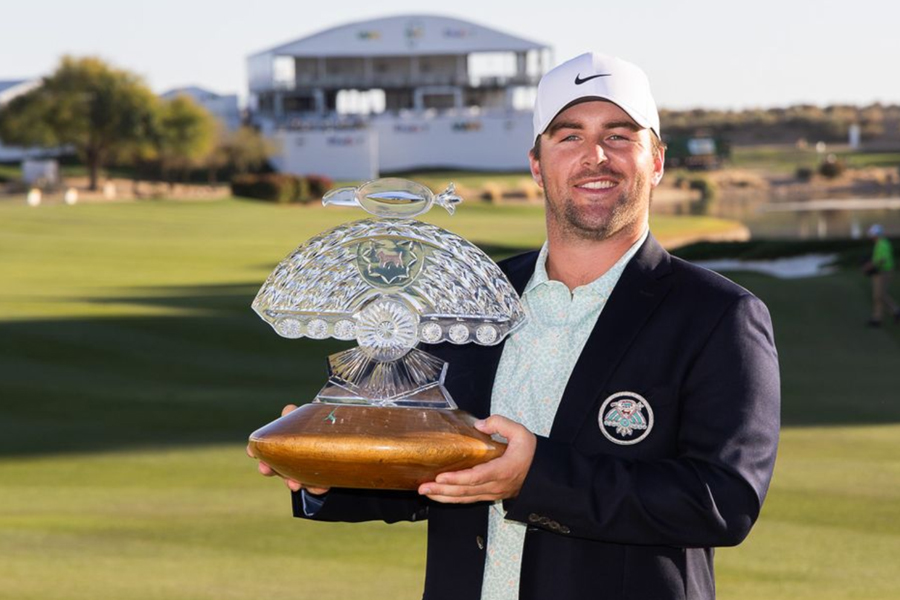 A man holding a trophy